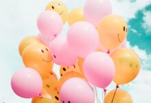 low-angle photo of pink and orange balloons